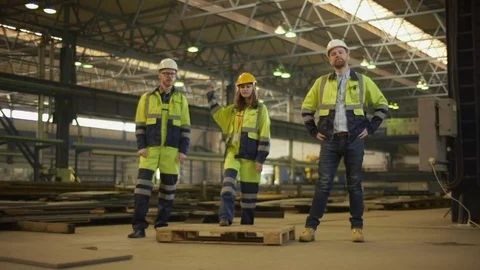 Three happy factory workers celebrating their success Stock Footage 106569742