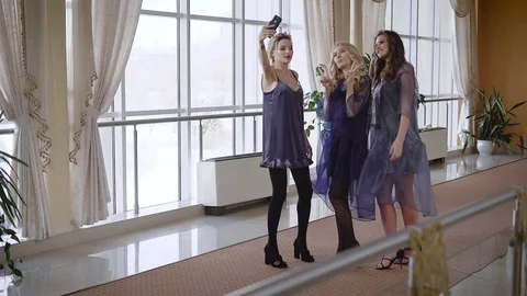 Three happy female friends posing for making selfie. Girls are celebrating Stock Footage