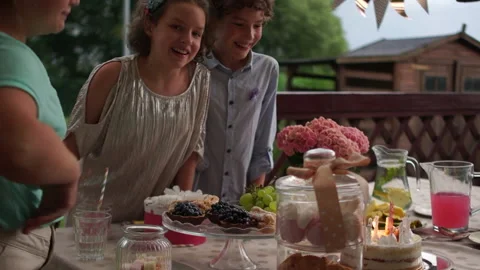Three happy friends are standing around the set birthday table. Catering concept Stock Footage 147264053