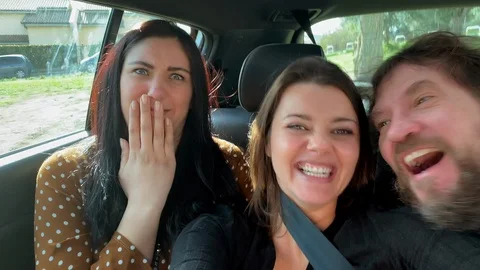 Three happy friends in car smiling kissing looking camera having fun Stock Footage 101260505