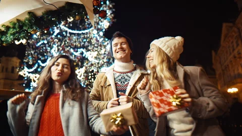 Three happy friends dance with gifts for New Year and Christmas on new year's Stock Footage 220688564