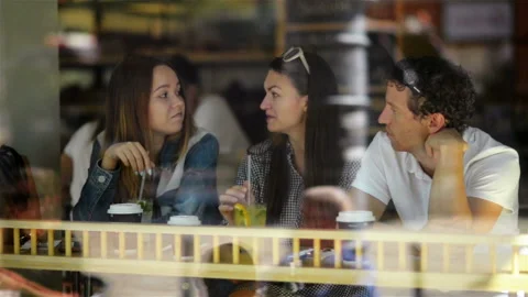 Three Happy Friends Drinking and Having a Good Time at Dinner Table in Cafe with Stock Footage 86511745