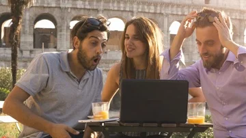 Three happy friends having video call with laptop sitting at bar restaurant Stock Footage 85597997