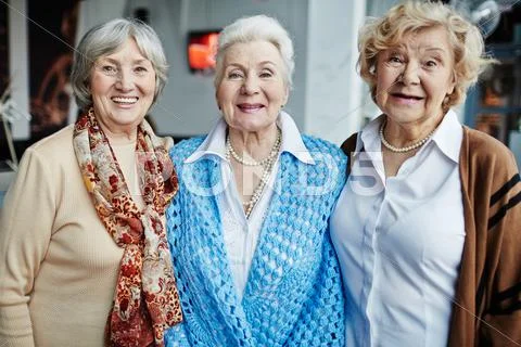 Three happy grannies looking at camera Stock Photos