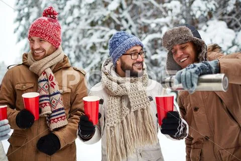 Three Happy Guys Having Hot Tea Outdoor In Winter