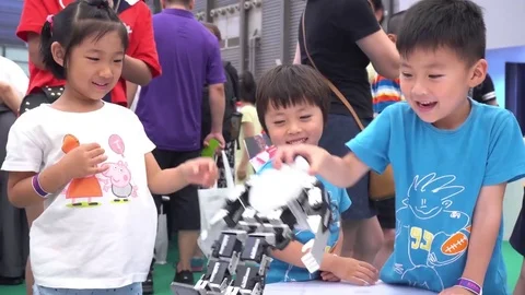 Three Happy Kids Playing with Robot at Hi-Tech Show Stock Footage