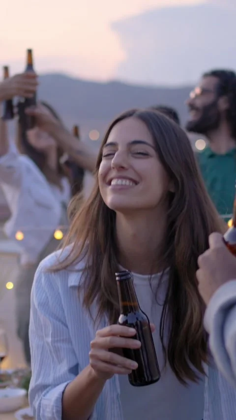 Three happy multiracial young people dancing at rooftop party with friends in Stock Footage 277121767