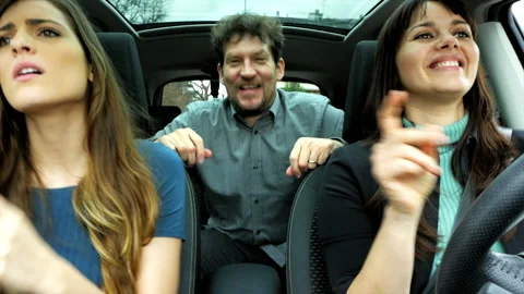 Three happy people in car dancing listening music feeling freedom after end o Stock Footage 158848035