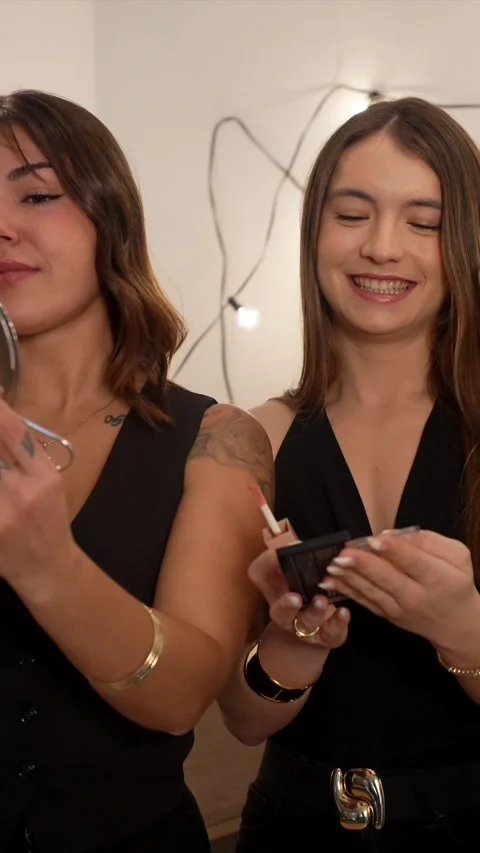 Three happy women applying makeup together for a party Stock Footage 324465928