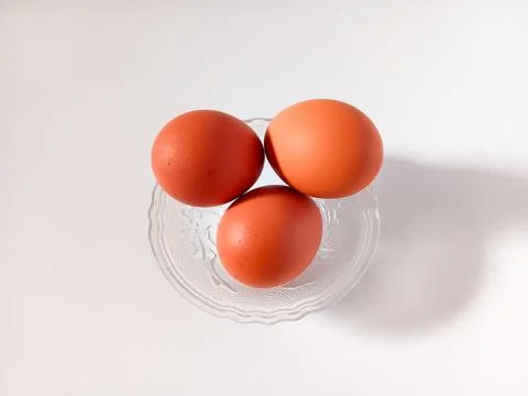 Three hard boiled eggs with brown shell isolated on white background. Stock Photos