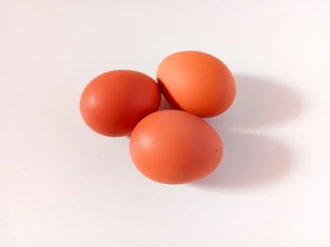 Three hard boiled eggs with brown shell isolated on white background. Foto stock