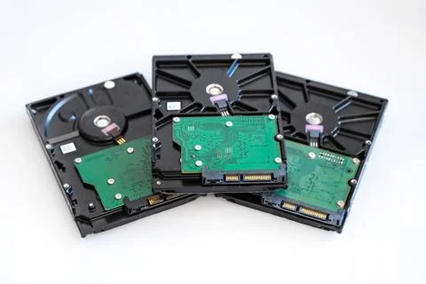 Three hard drives for computer systems are located on a light background Stock Photos