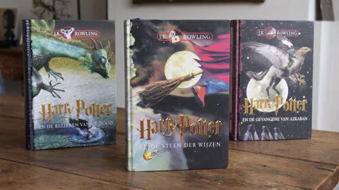 Three Harry Potter books on a table. Stock Footage 253655004