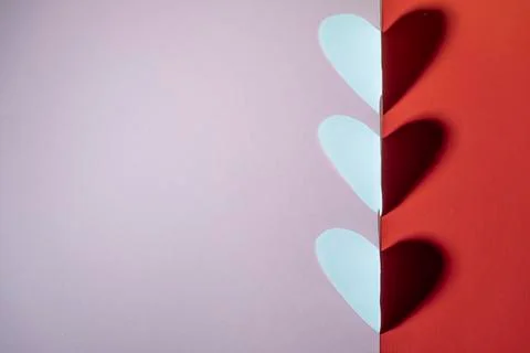 Three-hearted hearts with a shadow on a red-pink background. valentine's day  Stock Photos