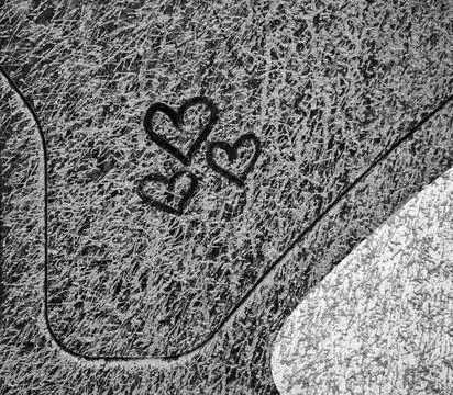 Three hearts drawn to layer of dried grey mud Stock Photos