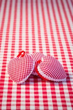 Three hearts on gingham tablecloth Stock Photos