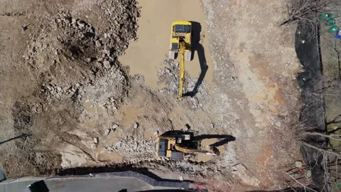 Three heavy excavators break up rock surface at the Dartmouth construction site Stock Footage 276626341