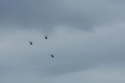 Three helicopter flying on gray sky Stock Photos