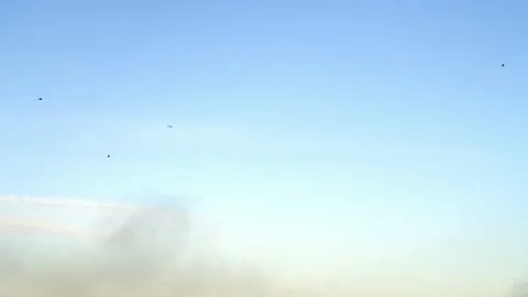 Three Helicopters Flying Above Cloud of Smoke Stock Footage 131597891