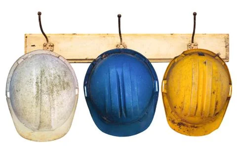 Three helmets hanging on a hat-rack Stock Photos