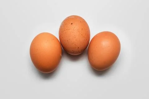 Three hen eggs in hard outer layer eggshell isolated on white Foto stock