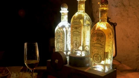 Three high quality tequila bottles lit up at the Fortaleza distillery in Mexico Stock Footage 90589447