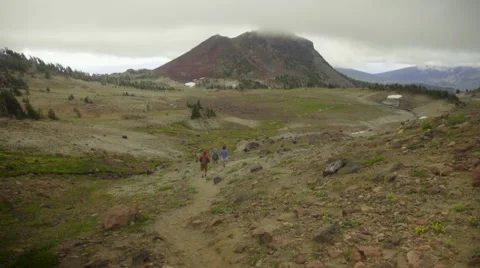 Three hikers follow mountain trail Stock Footage 59573073