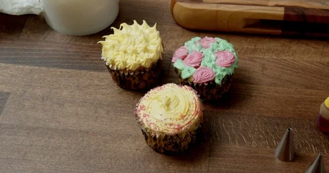Three home-decorated cupcakes Stock Footage 117012943