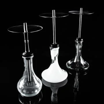 Three hookahs on a black background with a reflection. Stock Photos
