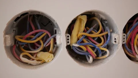 Three horizontal openings with wires in the wall for sockets. Stock-Footage 84885566