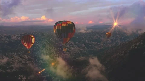 Three hot air balloons flight above mountains on the sunset or sunrise. Stock Footage 168402407