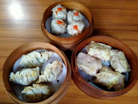 Three Hot Ready to Eat Dim Sum Boxes on Wooden Table Stock Photos
