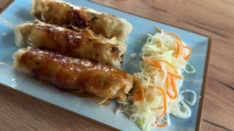 Three hot spring rolls on a plate, Chinese traditional dishes, Stock Footage 331714708