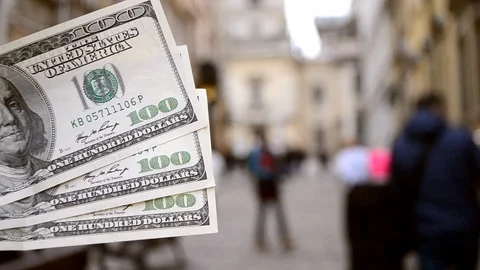 Three hundred dollar bills on blurred background of european street Stock Footage 126392174