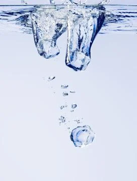 Three ice cubes in water Фото