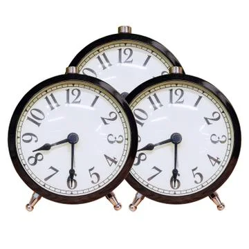 Three identical alarm clocks with white dial and black numbers on an isolated Foto stock