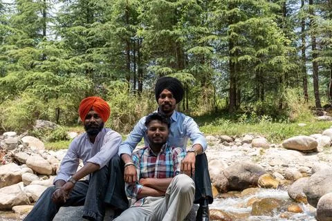 Three Indian friends including two Sikh men with turbans looking at camera .. 库存照片