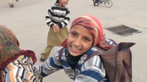Three Indian girlfriend are running home from school and playing on the street Stock Footage 69776550