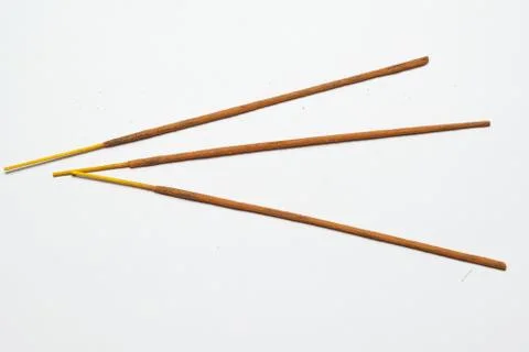 Three Indian incense sticks on a solid light background Stock Photos