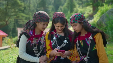 Three Indian rural girls using mobile phone to watch video on a OTT in village. Stock Footage 169946207