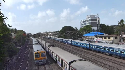 Three Indian Trains moving speeding in one frame, Train Traffic Mumbai India Stock Footage 130591830