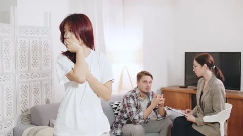 Three individuals are in a therapy session. Portrait of asian woman appears Stock Footage 320439870