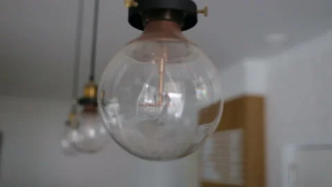 Three industrial-type lights are off. Indoors, real time Stock Footage 93514431