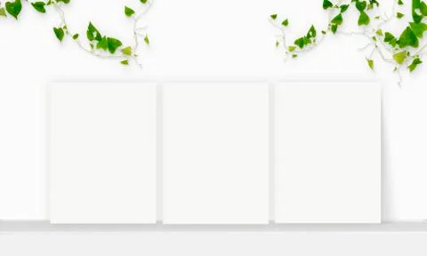 Three Interior vertical rectangular poster mockup standing on the table with  Stock Photos