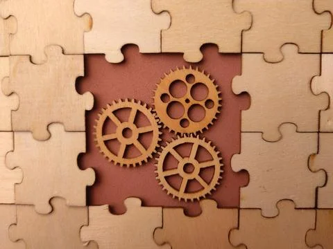 Three interlocking wooden gears placed within a missing section of a large .. Stockfoto's