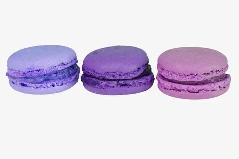 Three isolated macaroons in blue, violet and purple color Stock Photos