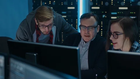 Three IT Engineers / Programmers Talking about Work, Using Computers. Technican Stock Footage 103272934