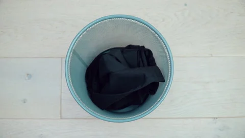 Three items of men's clothing fall into the trash. Sorting and processing waste Video stock 151770070