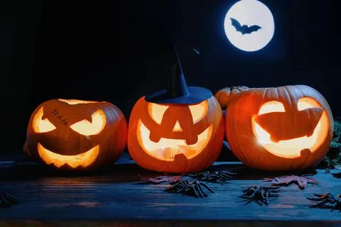 Three Jack-O'-Lanterns with Witch Hat and Full Moon Stock Photos