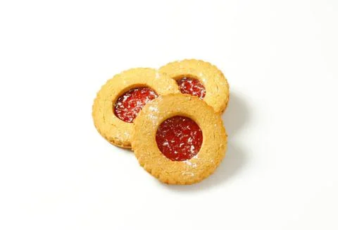 Three jam-filled cookies on plain background Stock Photos